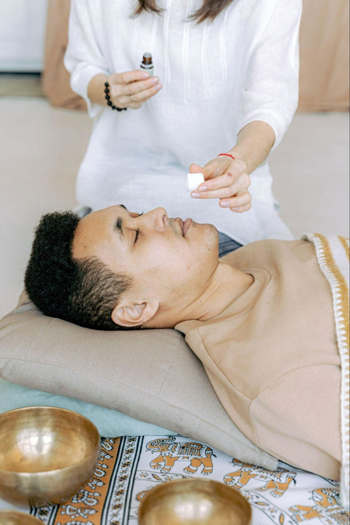 Man lying down smelling aromatherapy oil